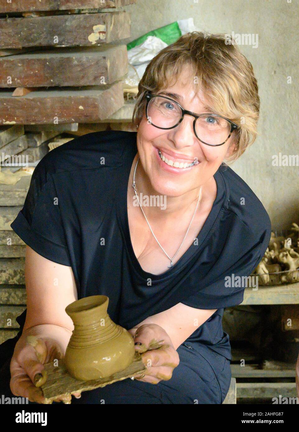Making traditional pottery using a foot powered wheel Stock Photo Alamy