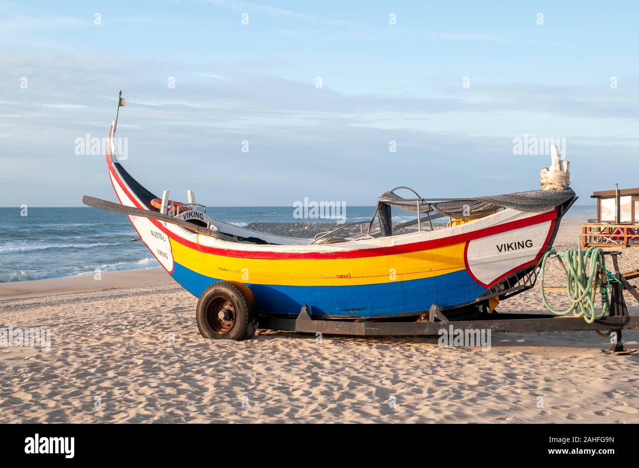 Traditional colorful Portuguese fishing boat on the beach at Vieira de Leiria. A Portuguese village and also a parish in the municipality of Marinha G Stock Photo