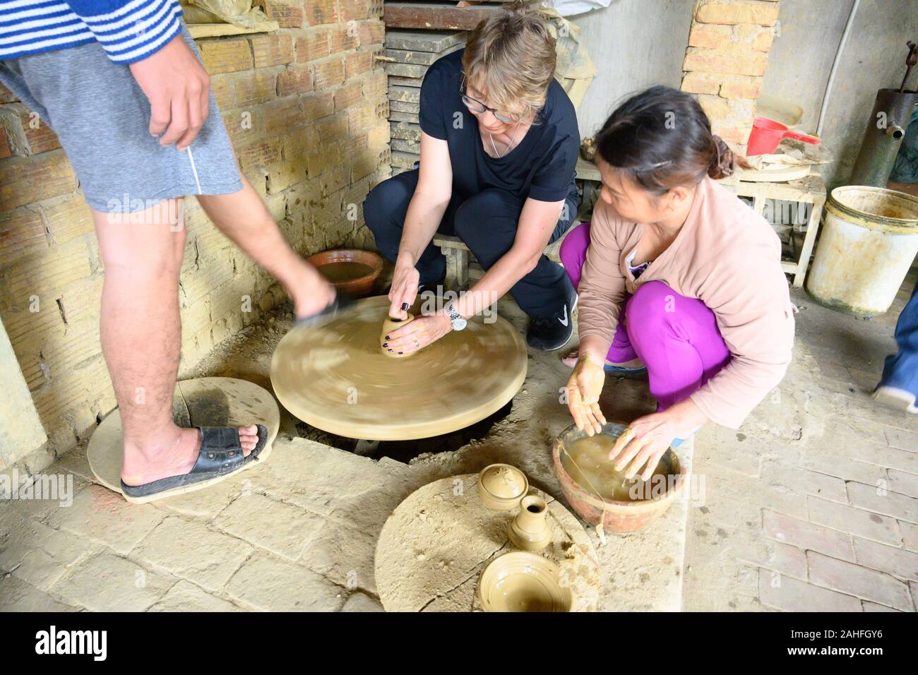 Making traditional pottery using a foot powered wheel Stock Photo Alamy