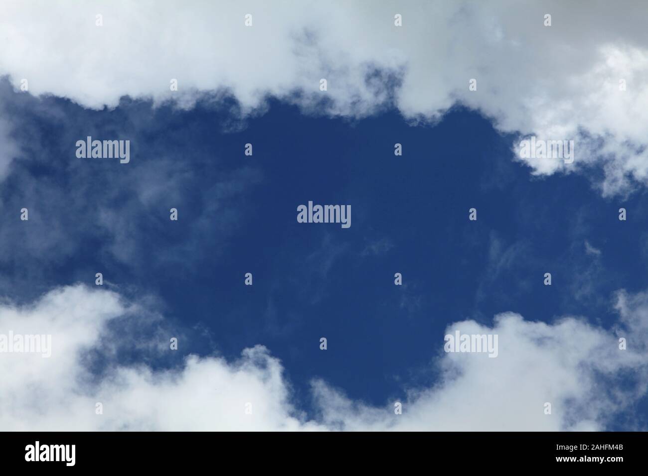 A huge cumulus and cumulonimbus clouds conglomeration on the blue sky background. The skies landscape in summer Stock Photo