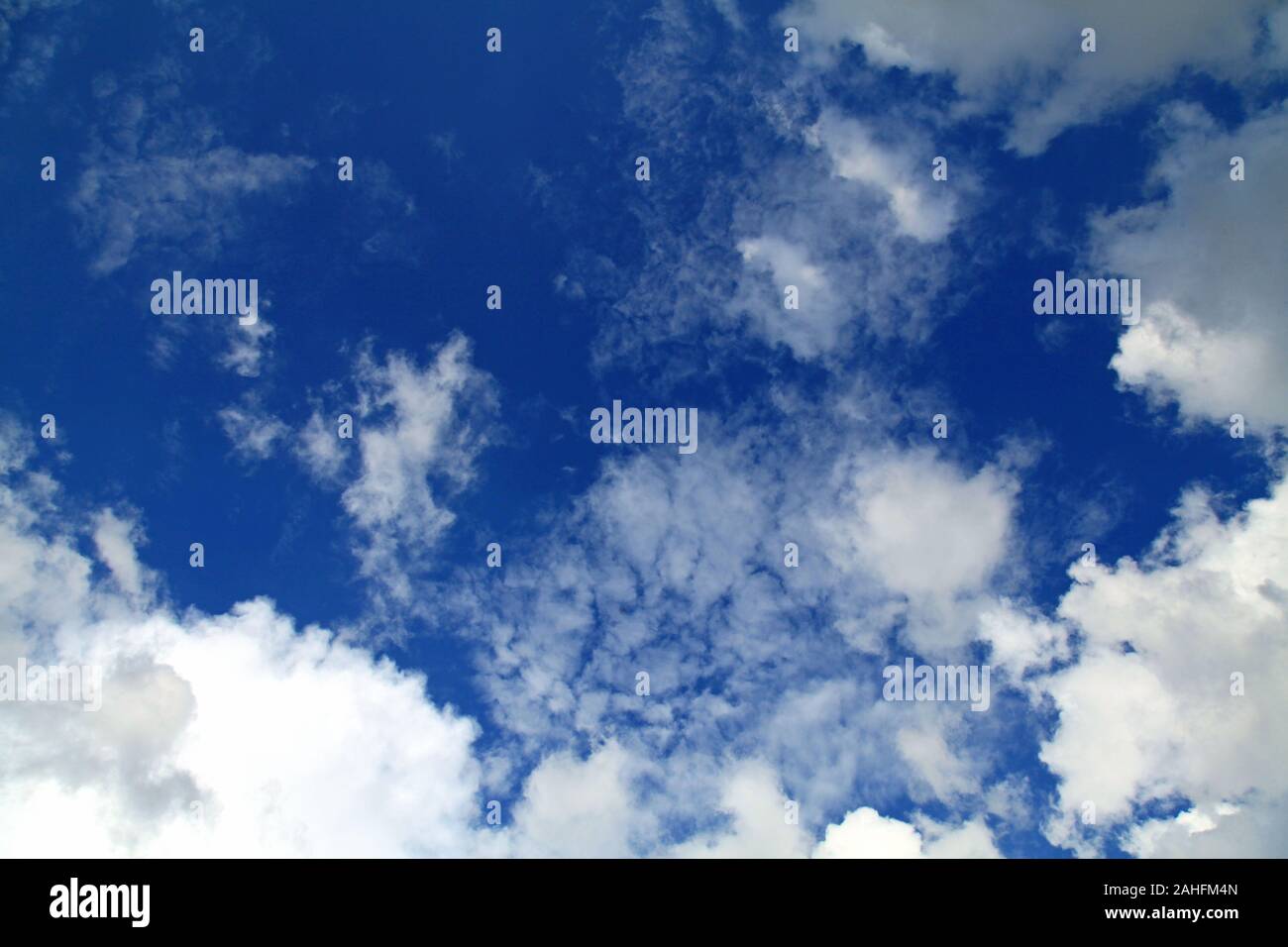 A huge cumulus and cumulonimbus clouds conglomeration on the blue sky background. The skies landscape in summer Stock Photo