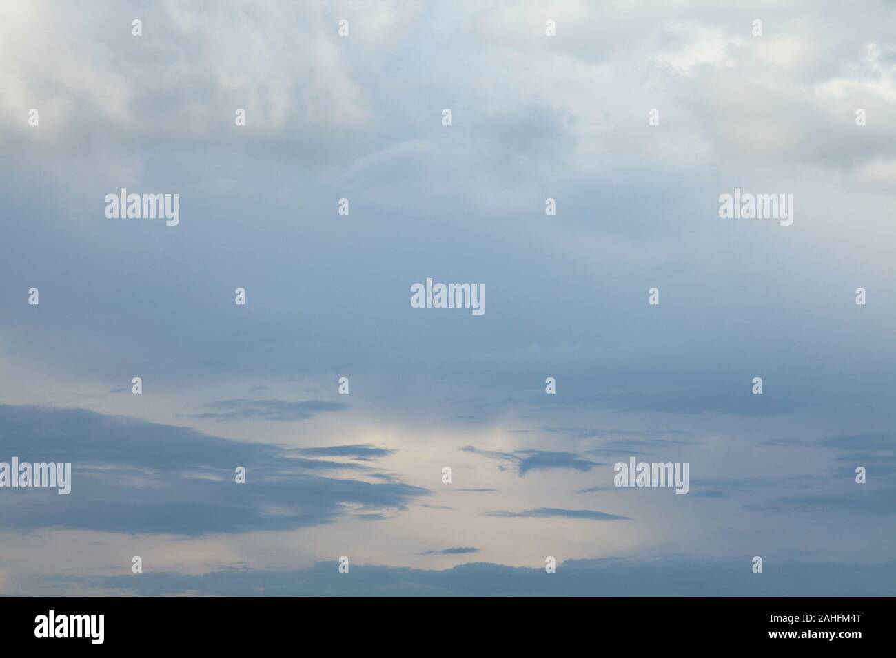 A huge cumulus and cumulonimbus clouds conglomeration on the blue sky background. The skies landscape in summer Stock Photo