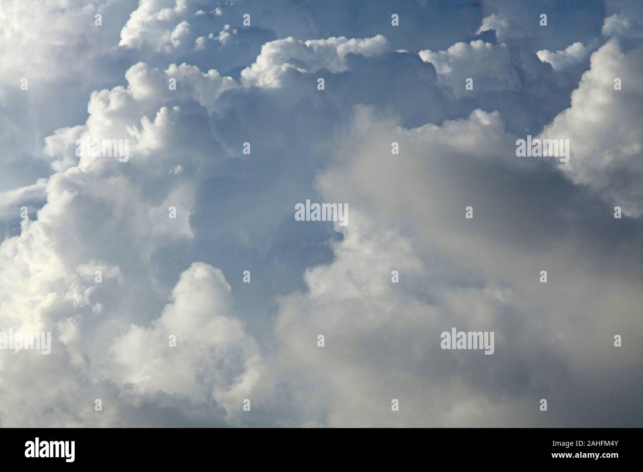 A huge cumulus and cumulonimbus clouds conglomeration on the blue sky background. The skies landscape in summer Stock Photo