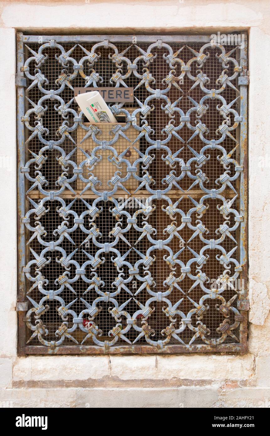 Letter box behind ornate metal lattice. Venice, Italy 2019. Stock Photo