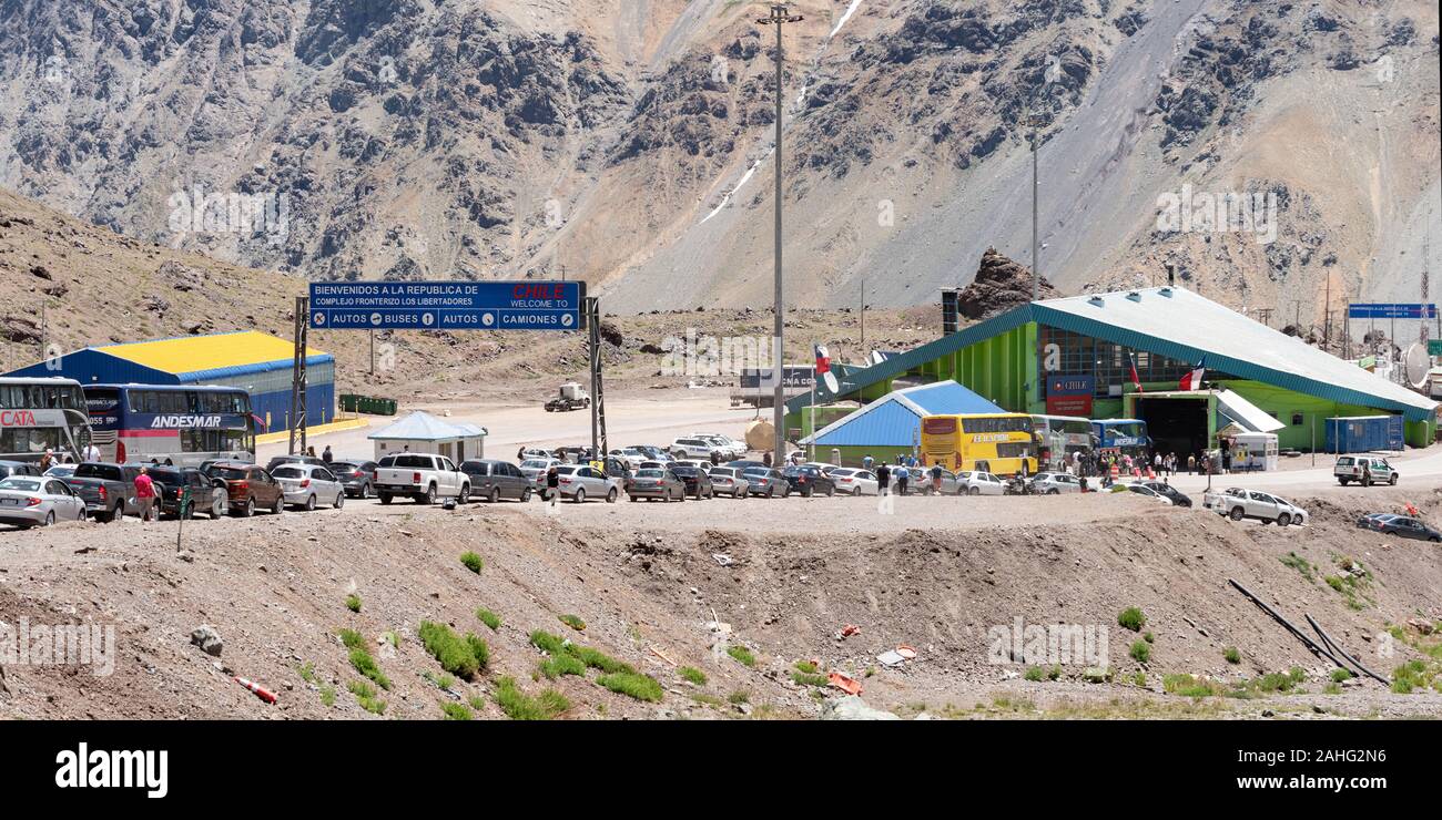 Traffic queues waiting to pass from Argentina into Chile in the Andes on the route from Mendoza to Santiago. Stock Photo