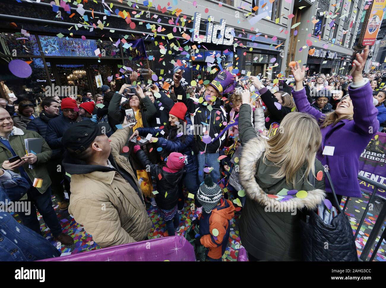 New York, USA. 29th Dec, 2019. Revelers react as confetti falls from ...