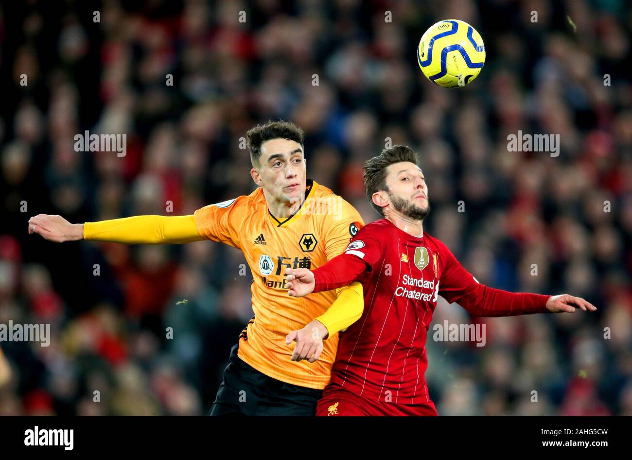 Liverpool's Sadio Mane's shot hits off the shoulder of Liverpool's Adam Lallana (right) and into the net resulting in their sides first goal of the game during the Premier League match at Anfield Stadium, Liverpool. Stock Photo