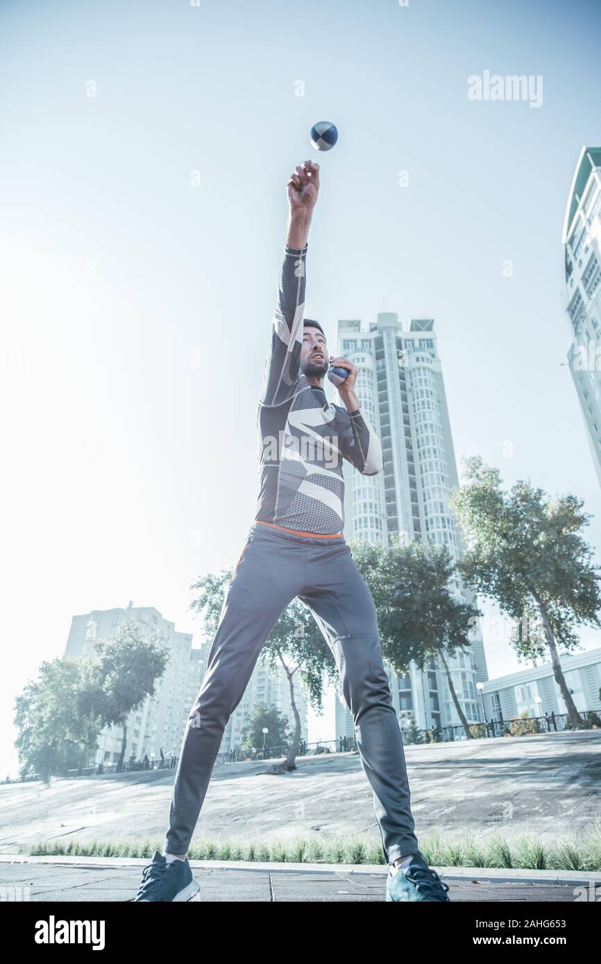 Fast man jumping and catching calls in the air Stock Photo