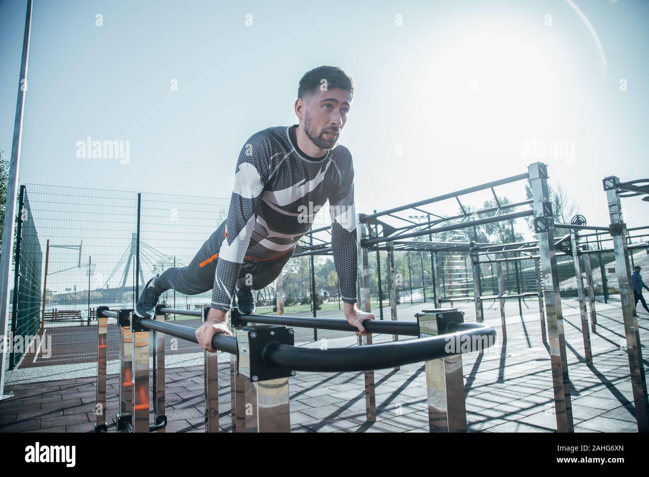 Serious sportsman looking calm while doing the push ups Stock Photo