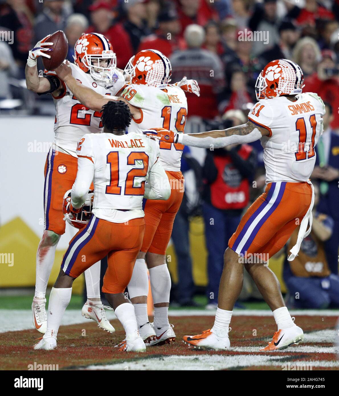 Clemson Tigers Nolan Turner (24) is greeted by teammates K'Von Wallace (12), Tanner Muse (19) and Isiah Simmon (11) after intercepting a pass in the endzone against the Ohio State Buckeyes in the College football semi final game at the Fiesta Bowl Saturday, December 28, 2019 in Glendale, Arizona.    Photo by Aaron Josefczyk/UPI Stock Photo