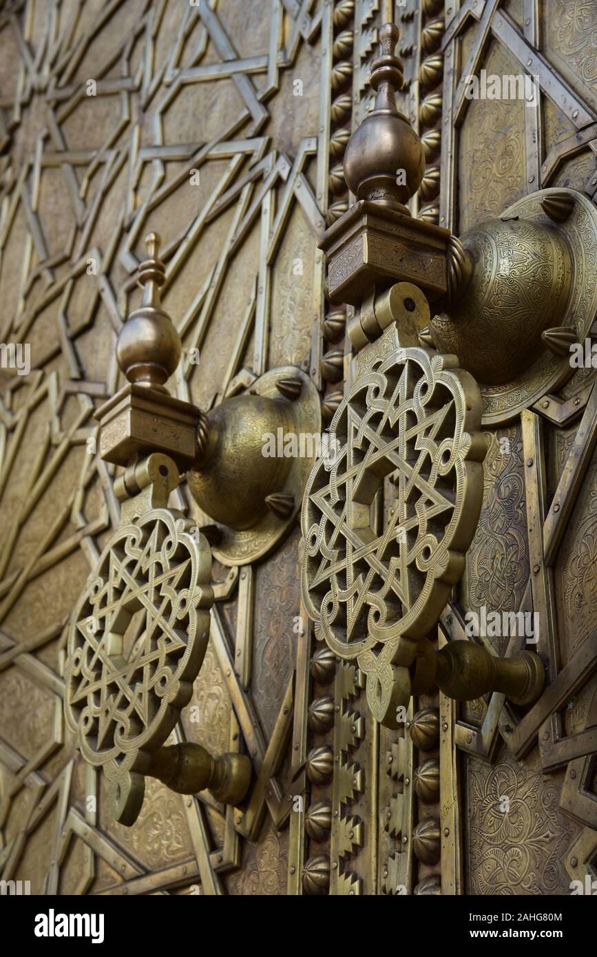 Exquisitely engraved bronze doors fitted with a pair of fine, ornate
