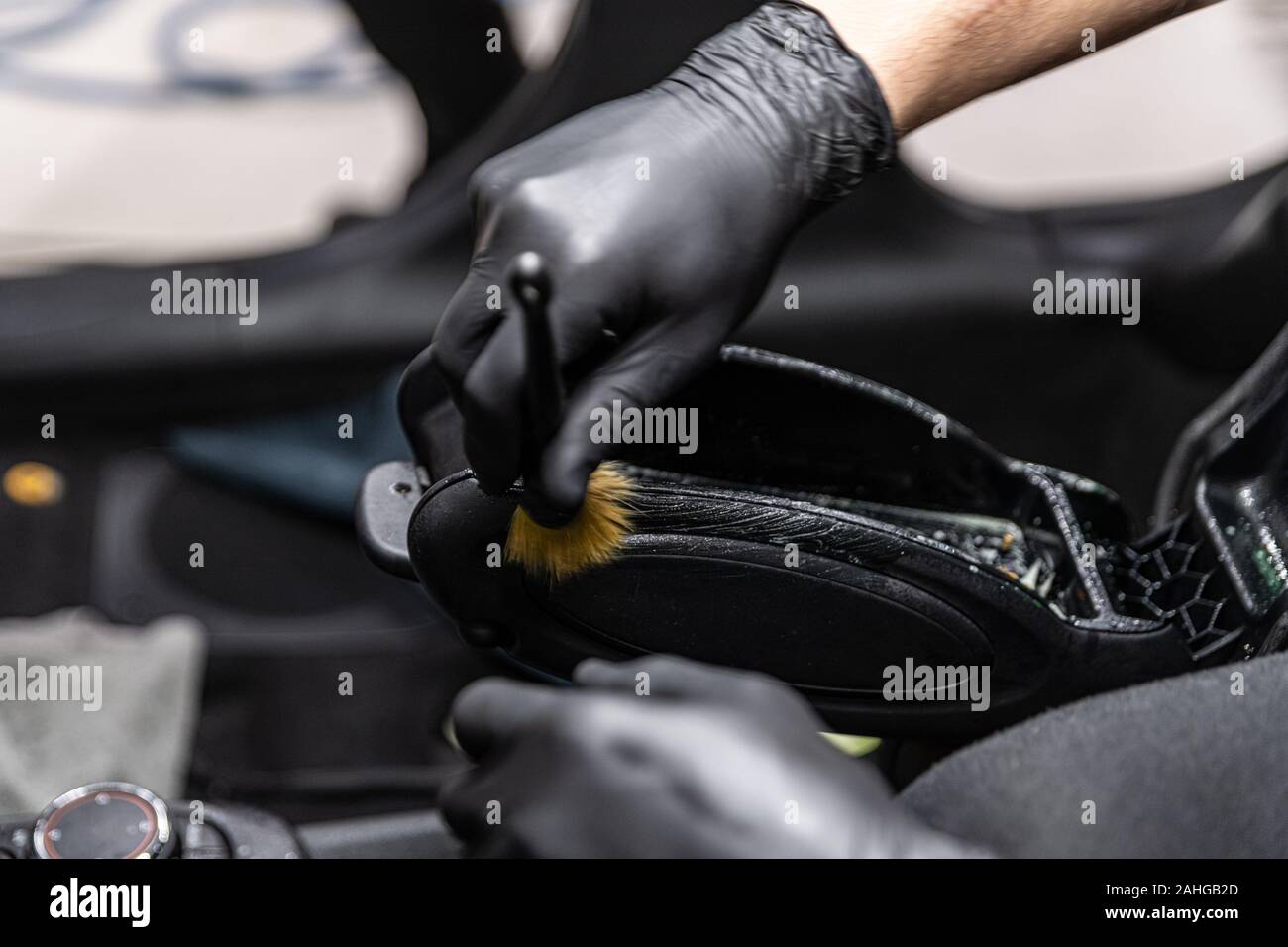 Car Wash Worker Cleaning Car Interior With Brush Stock Photo