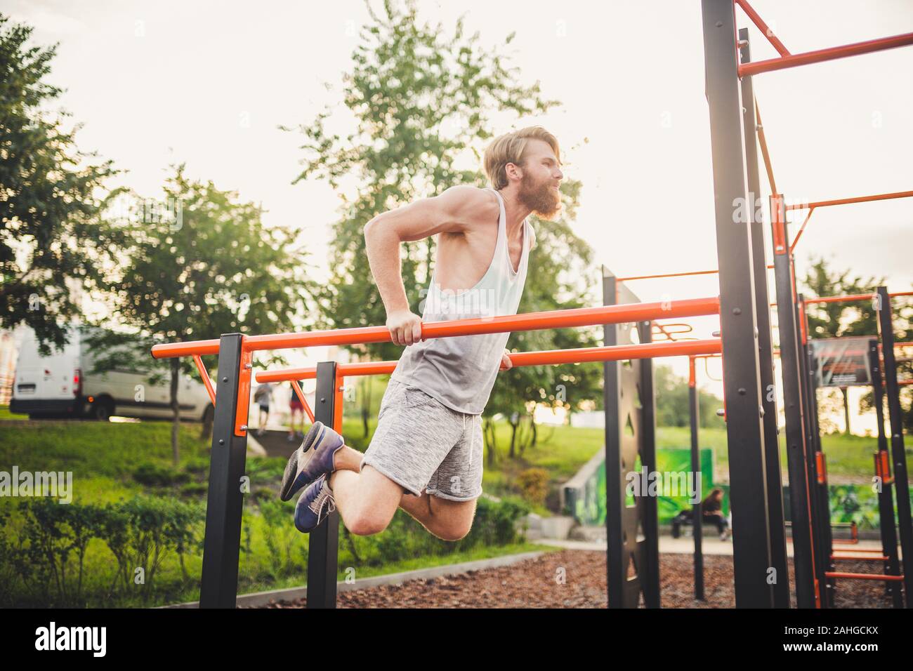 Fit Man Workout Out Arms On Dips Horizontal Bars Training Triceps And