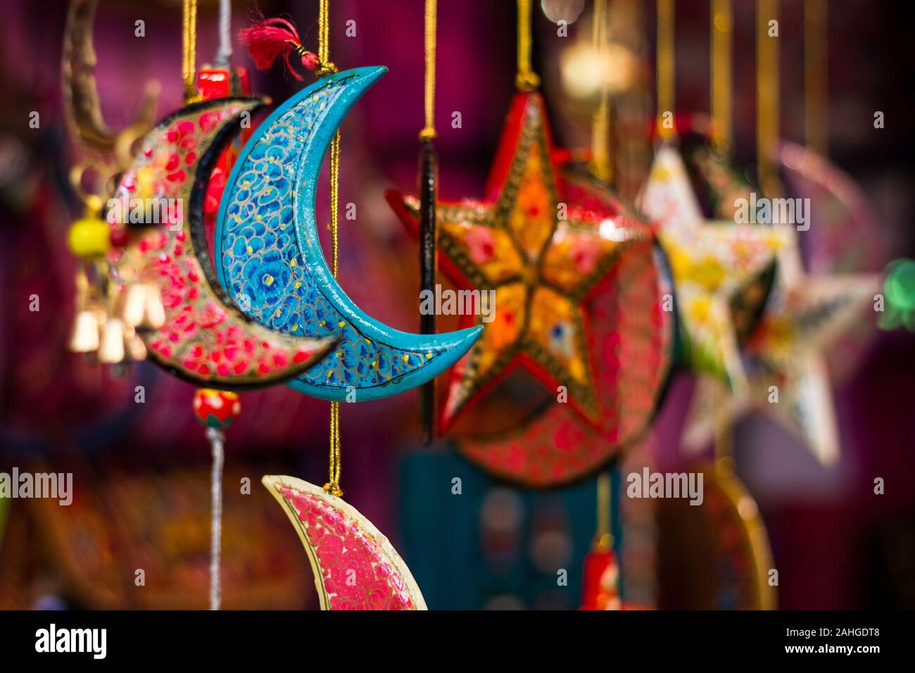 Colorful hanging ornaments including blue half moon on street market Stock Photo