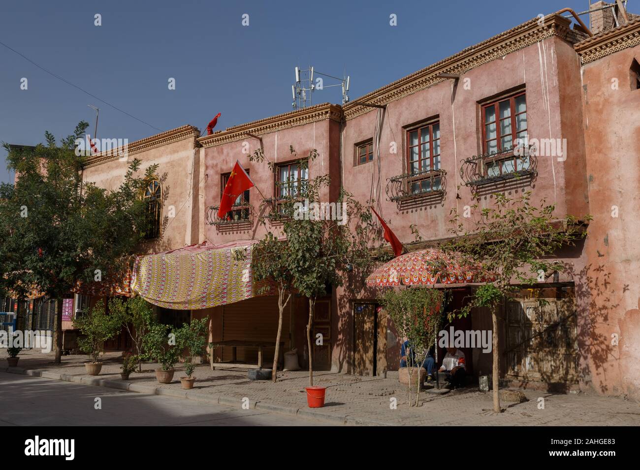 View on traditional Uyghur houses in Kashgar Old Town. Due to Chinese National Holiday Chinese flags are mounted on the houses. Stock Photo