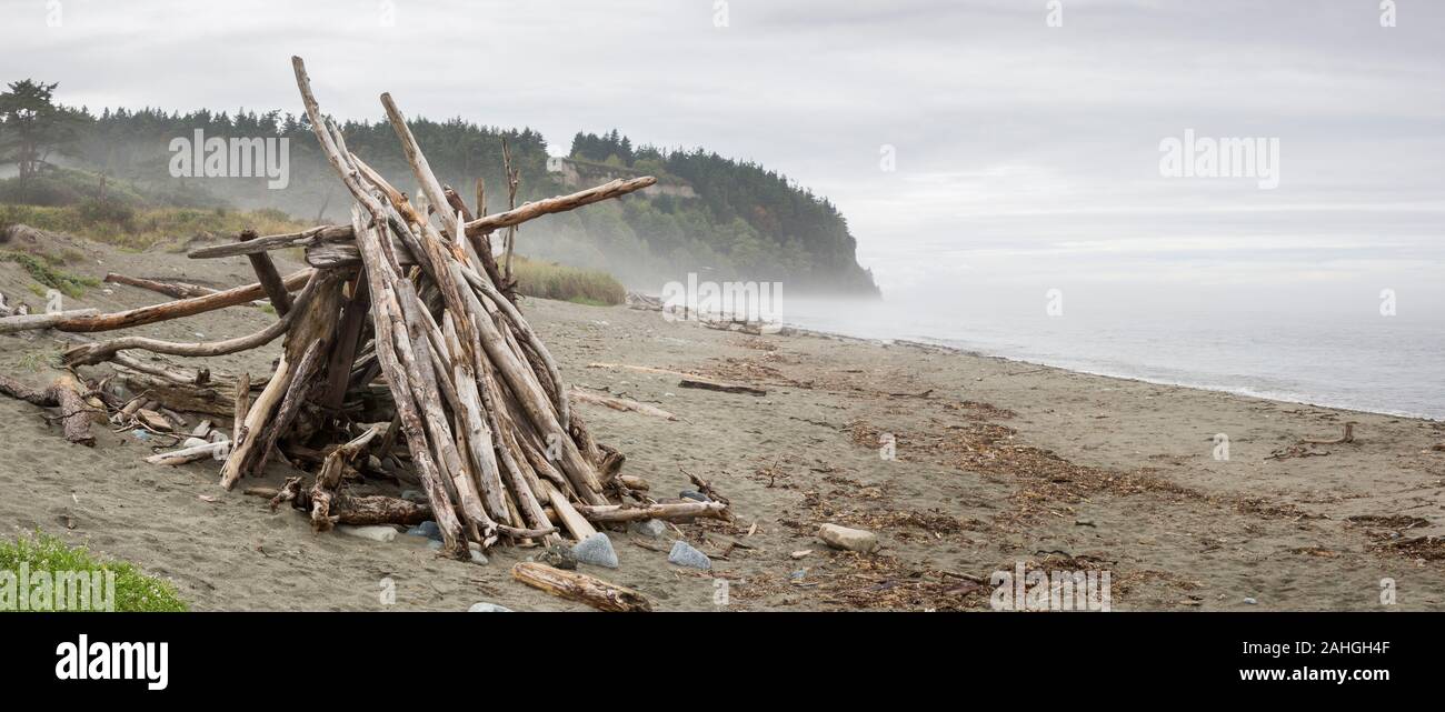 Temporary driftwood windbreak shelter along a Puget Sound beach near Port Townsend, Washington State, United States Stock Photo