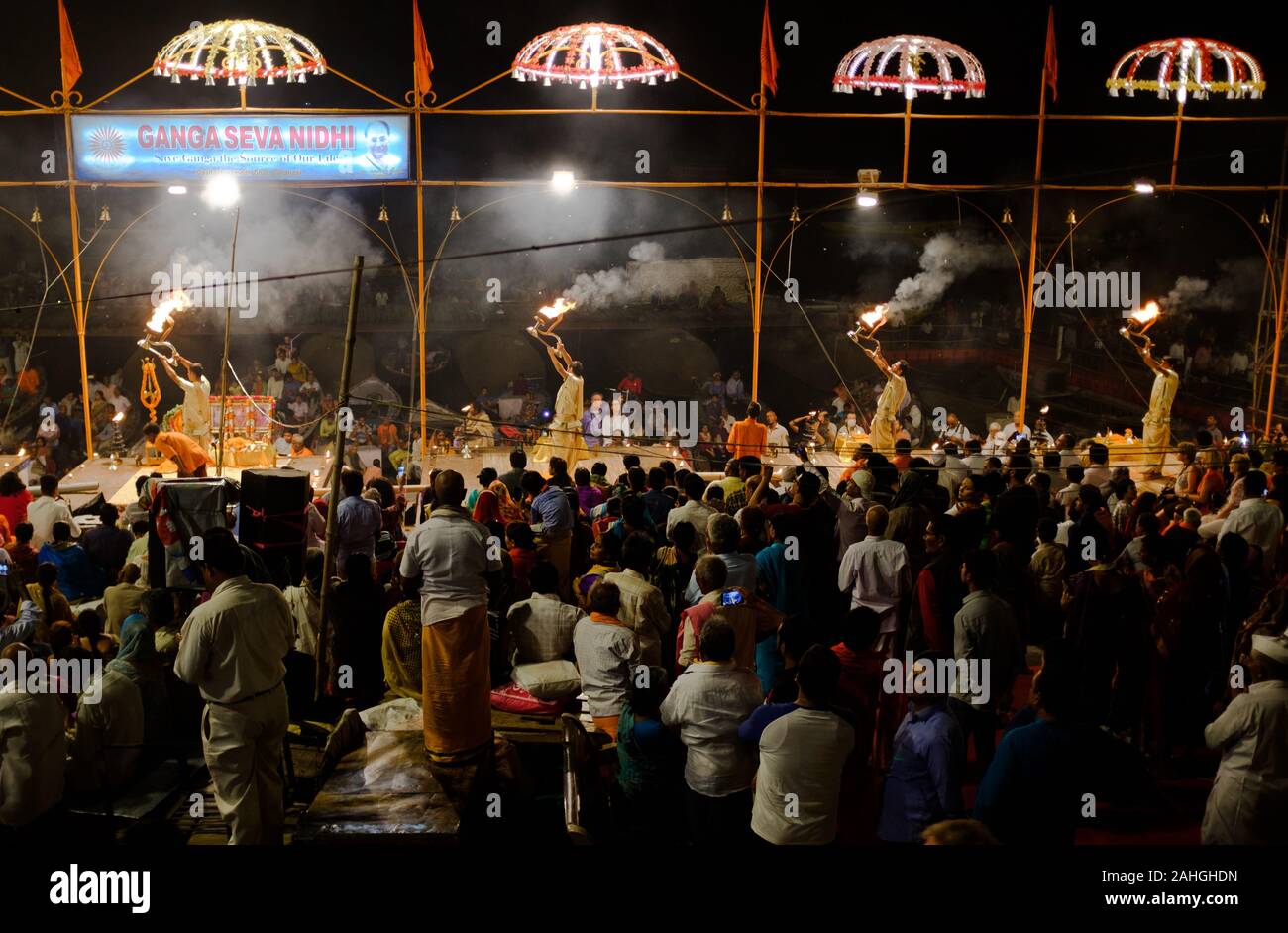 Pandits, or Hindu priests, perform a devotional ritual using fire as an offering to the Goddess Ganga. Ganga Aarti, Ganges River, Varanasi, India. Stock Photo