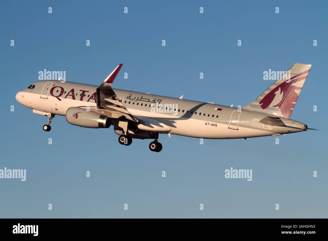 Qatar Airways Airbus A320-200 passenger jet airplane climbing on takeoff against a blue sky. Modern aviation. Stock Photo