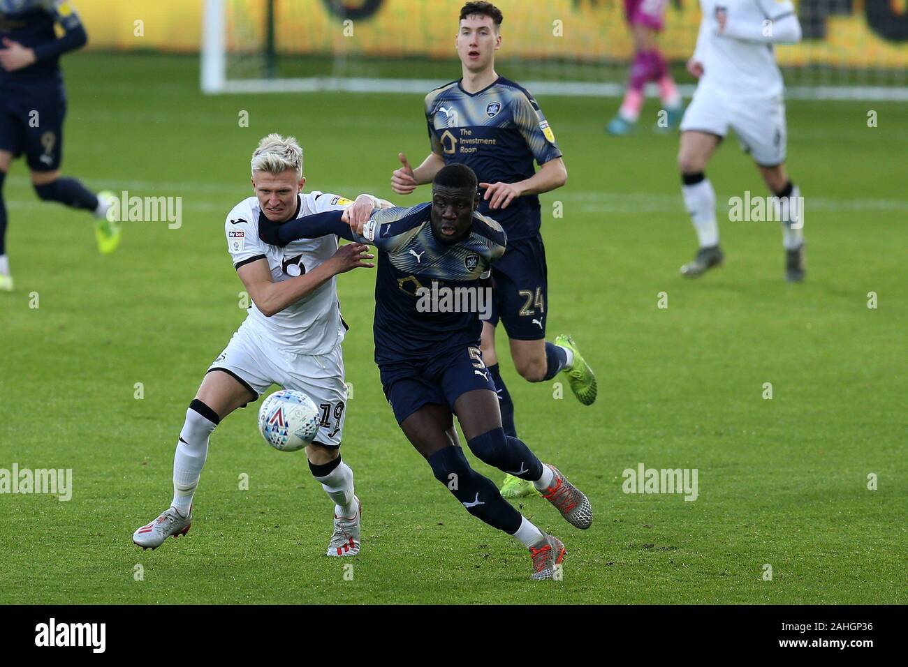 Swansea, UK. 29th Dec, 2019. Bambo Diaby of Barnsley (5) holds off Sam Surridge of Swansea city. EFL Skybet championship match, Swansea city v Barnsley at the Liberty Stadium in Swansea, South Wales on Sunday 29th December 2019. this image may only be used for Editorial purposes. Editorial use only, license required for commercial use. No use in betting, games or a single club/league/player publications. pic by Andrew Orchard/Andrew Orchard sports photography/Alamy Live news Credit: Andrew Orchard sports photography/Alamy Live News Stock Photo