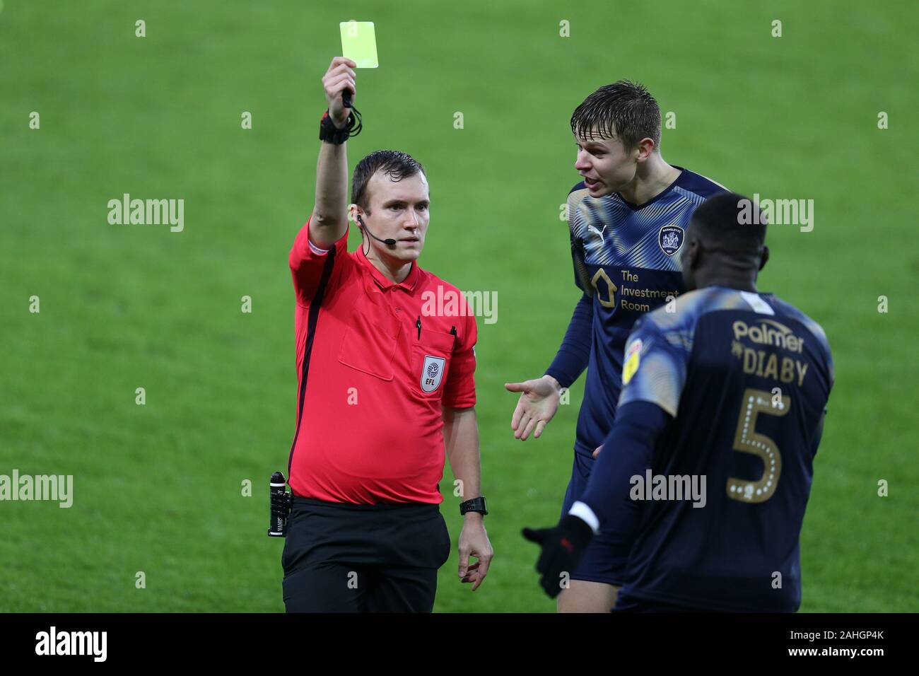 Swansea, UK. 29th Dec, 2019. Bambo Diaby of Barnsley (5) is booked by referee Antony Coggins (l). EFL Skybet championship match, Swansea city v Barnsley at the Liberty Stadium in Swansea, South Wales on Sunday 29th December 2019. this image may only be used for Editorial purposes. Editorial use only, license required for commercial use. No use in betting, games or a single club/league/player publications. pic by Andrew Orchard/Andrew Orchard sports photography/Alamy Live news Credit: Andrew Orchard sports photography/Alamy Live News Stock Photo