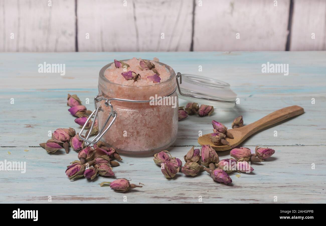 Homemade spa of rose bath salts on a light wooden background. Cosmetics and natural medicine Stock Photo