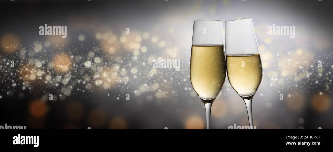 https://c8.alamy.com/comp/2AHGPXH/happy-new-year-2020-two-champagne-glass-flutes-toasting-against-a-dark-bubble-bokeh-background-party-concept-in-panoramic-format-with-copy-space-2AHGPXH.jpg