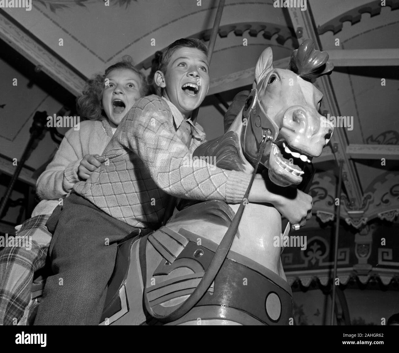 Children on a merry-go-round 1946 Stock Photo
