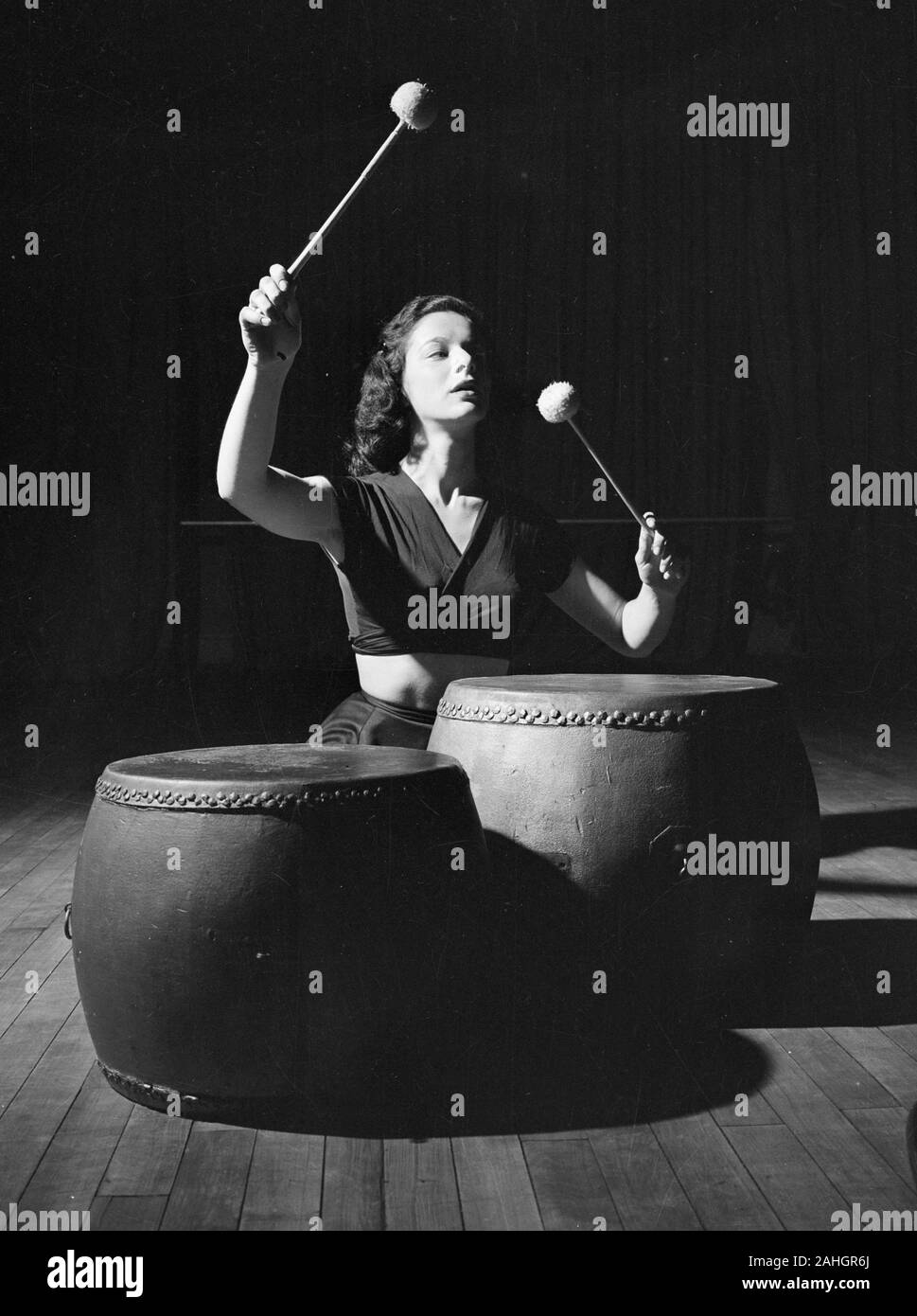 Woman banging drums 1946 Stock Photo