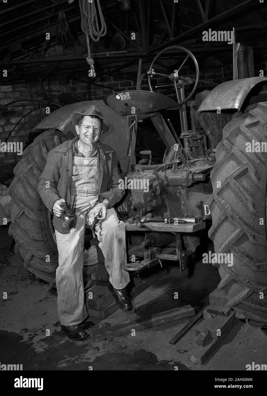 Farmer working on his tractor 1946 Stock Photo