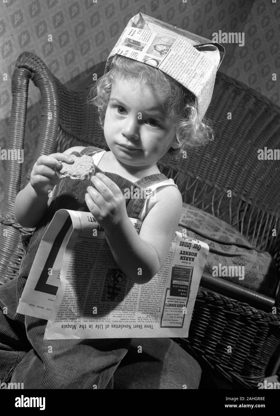 Girl with a newspaper hat Stock Photo