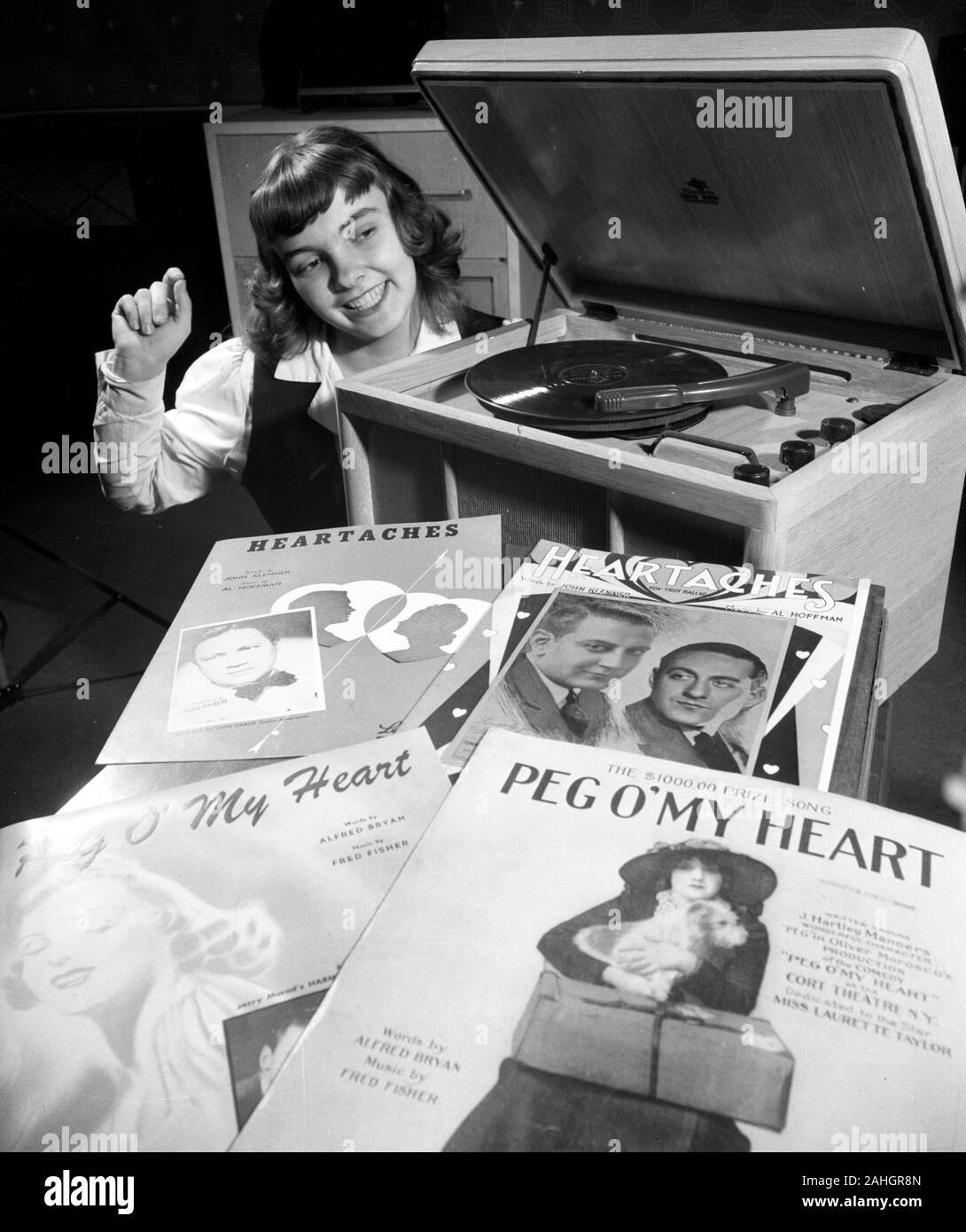 Teenager listening to music on a phonograph 1946 Stock Photo