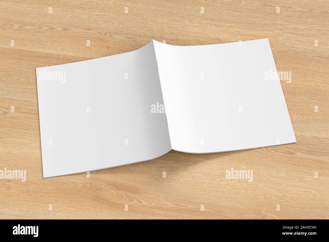 Square brochure or booklet cover mock up on wooden background. Brochure is open and upside down. Isolated with clipping path around brochure. Side vie Stock Photo