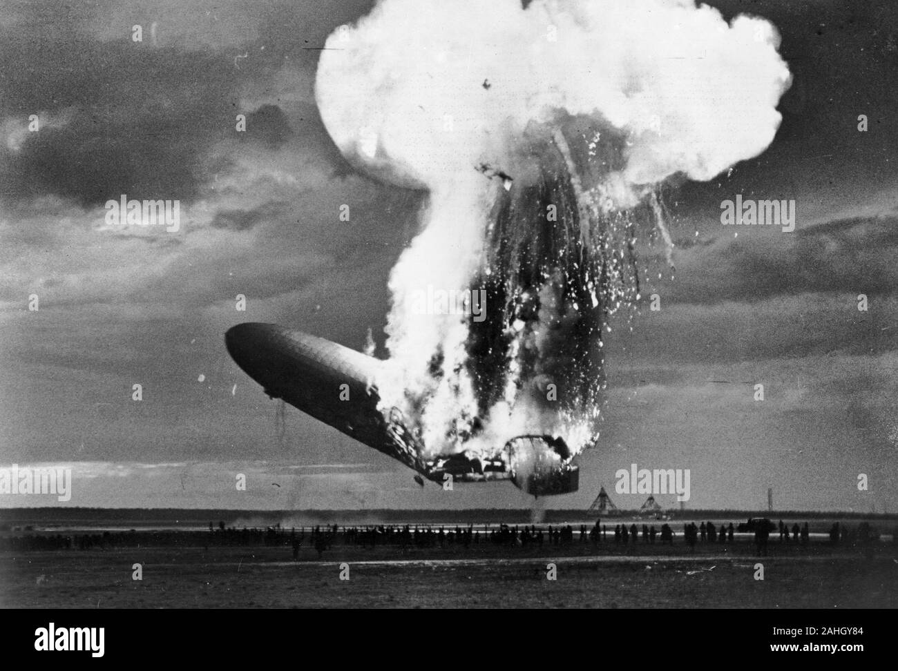 Left side view of German airship Zeppelin LZ 129 Hindenburg burning at Lakehurst, New Jersey, 6 May 1937; the disaster occured while the airship was landing. In this photo, the rear half of the ship is on fire but the ship is still above the ground; nose is pitched sharply upwards. Stock Photo