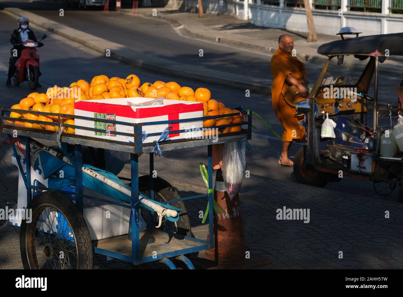 A mobile fruit vendor's cart in Bangkok, Thailand, laden with