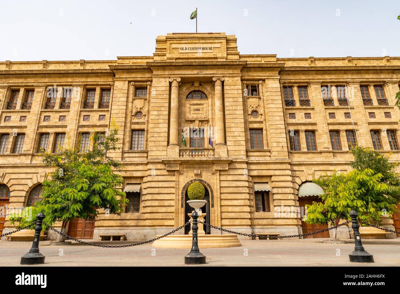 Karachi Imperial Old Custom House Picturesque View with Waving Pakistan Flag on Top of Roof on a Cloudy Day Stock Photo