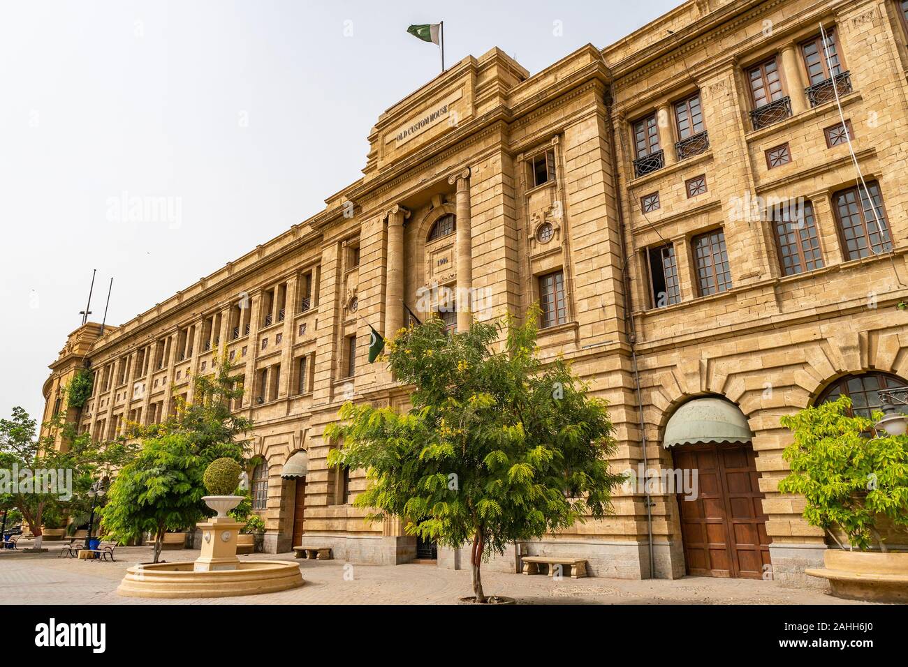 Karachi Imperial Old Custom House Picturesque View with Waving Pakistan Flag on Top of Roof on a Cloudy Day Stock Photo