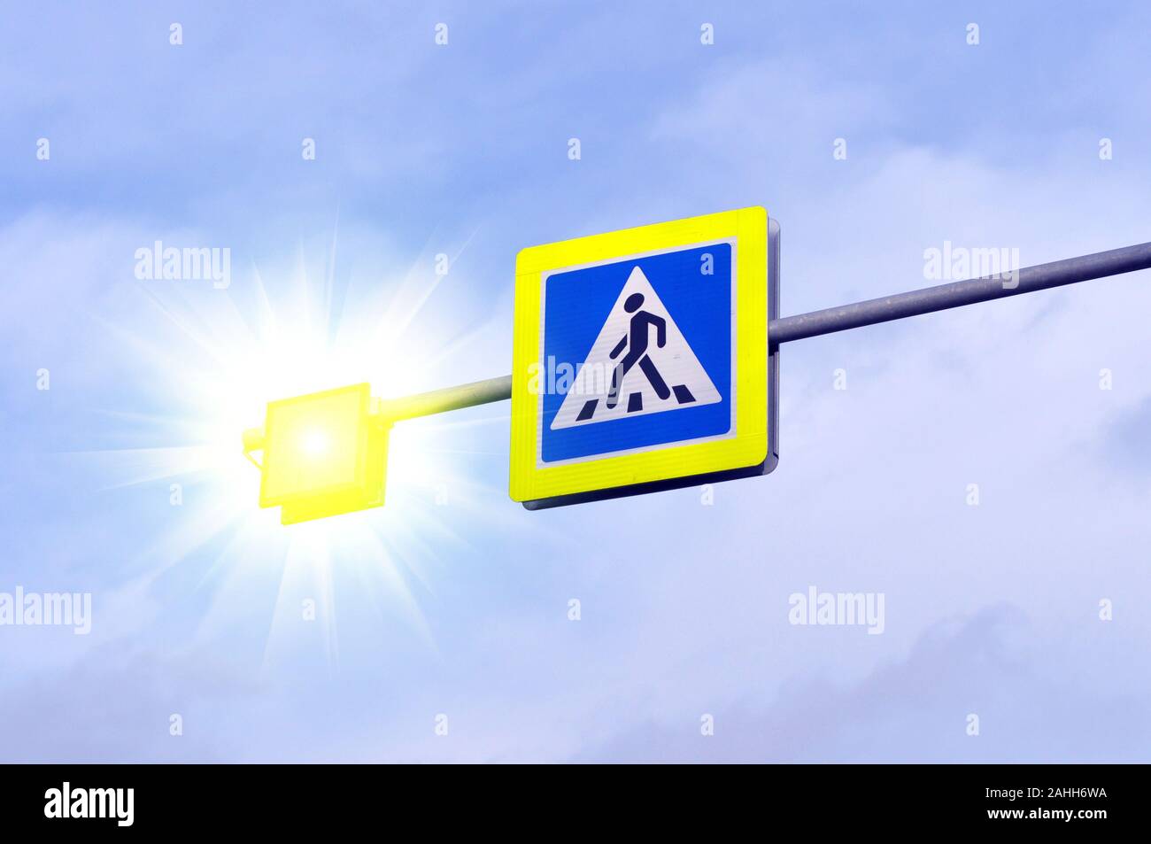 Pedestrian crossing road sign symbol. Bright blue and and luminous yellow pedestrian crosswalk sign Stock Photo