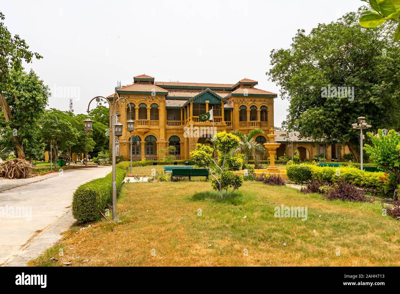 Karachi Quaid e Azam Jinnah House Museum Picturesque View with Garden and Waving Pakistan Flag on a Cloudy Day Stock Photo