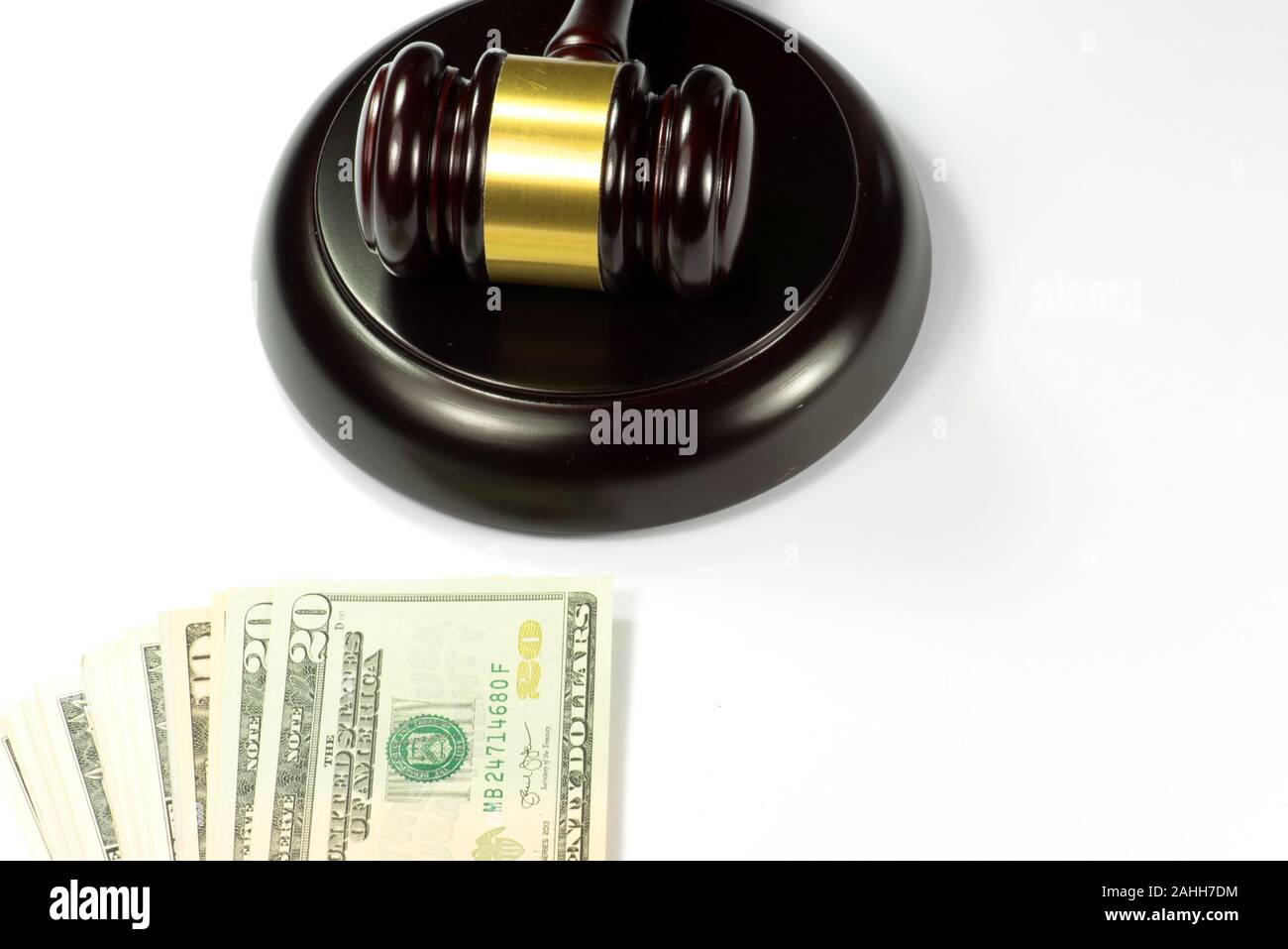 A judge gavel and dollar bills Stock Photo