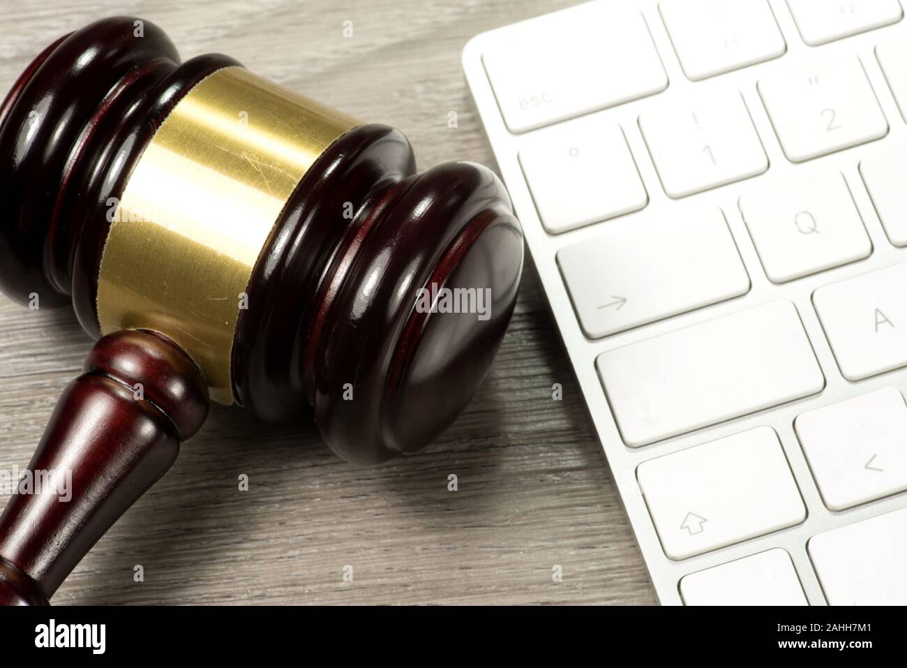 A judge gavel or auction hammer and a computer Stock Photo