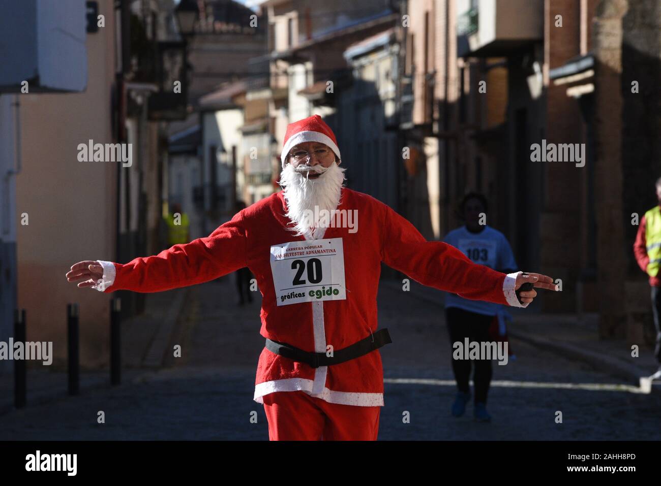 A man dressed as Santa Claus takes part during the race.During the last days of the year, hundreds of Spanish towns and cities celebrate popular races called San Silvestre. The most famous, known as San Silvestre Vallecana, will be celebrated next Tuesday, 31 December in Madrid. Stock Photo
