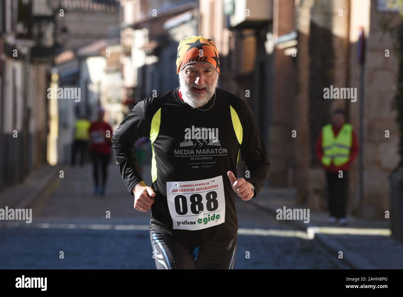 A man takes part during the race.During the last days of the year, hundreds of Spanish towns and cities celebrate popular races called San Silvestre. The most famous, known as San Silvestre Vallecana, will be celebrated next Tuesday, 31 December in Madrid. Stock Photo