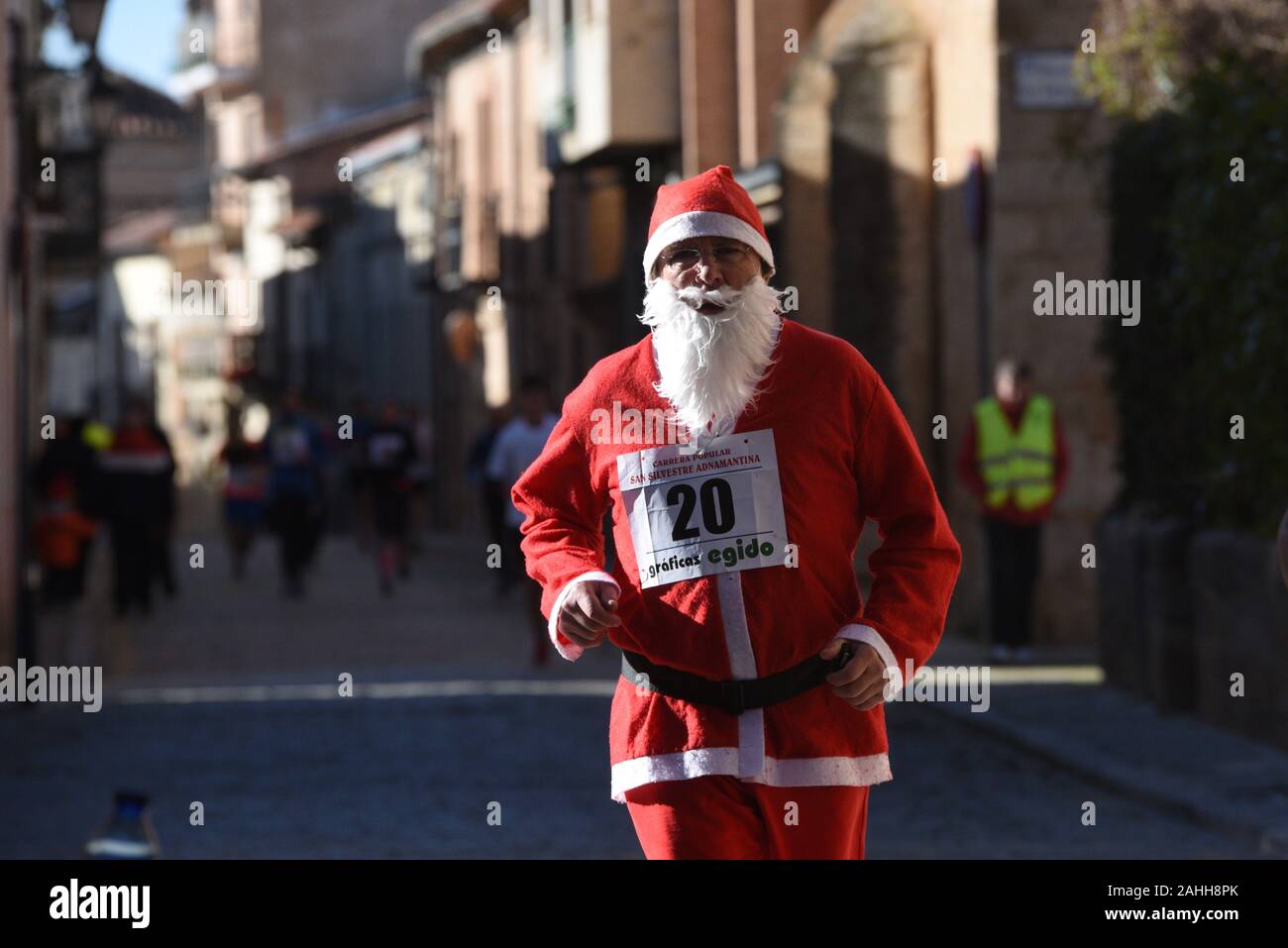 A man dressed as Santa Claus takes part during the race.During the last days of the year, hundreds of Spanish towns and cities celebrate popular races called San Silvestre. The most famous, known as San Silvestre Vallecana, will be celebrated next Tuesday, 31 December in Madrid. Stock Photo