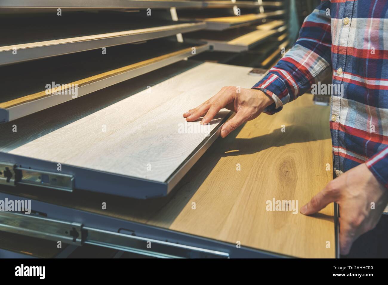man choosing kitchen countertop materials at interior design shop Stock Photo