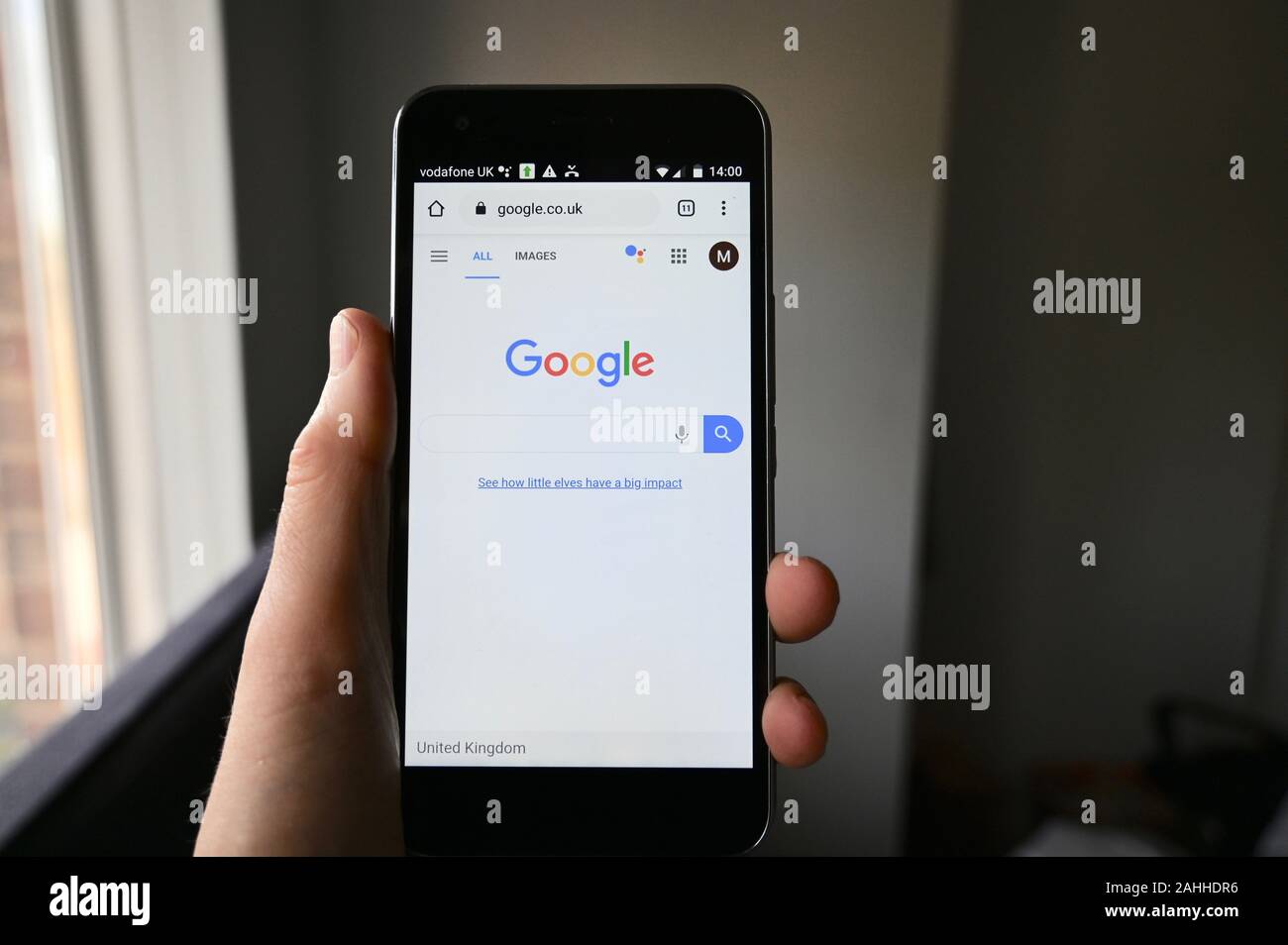 Mobile phone screen displaying Google webpage. Stock Photo