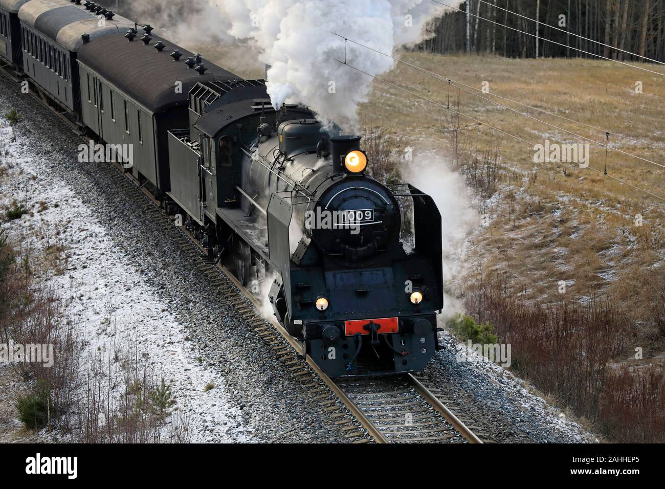 VR Hr1 Class steam locomotive Ukko-Pekka 1009 pulling carriages on a winter morning south of Salo, Finland. December 27, 2019. Elevated view. Stock Photo