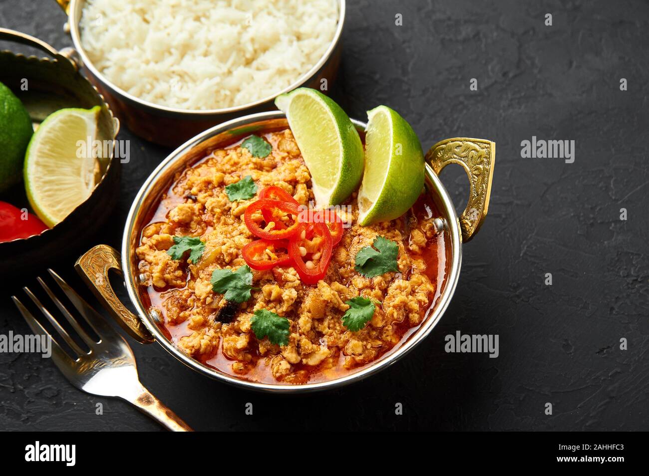 Chicken keema in traditional indian copper kadai at dark slate