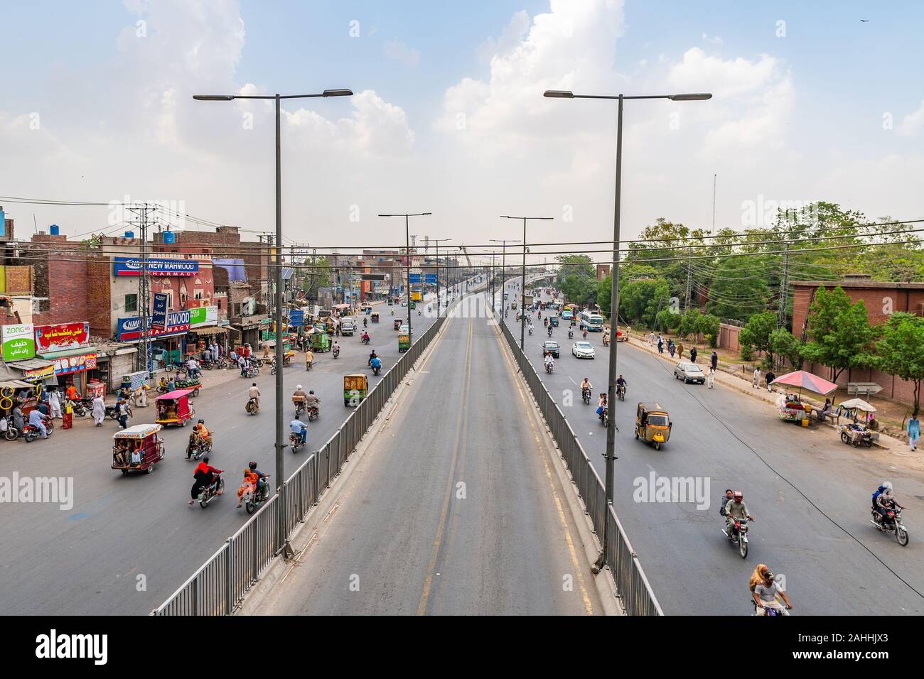 Lahore Data Darbar Road Picturesque View with Busy Traffic on a Cloudy Blue Sky Day Stock Photo