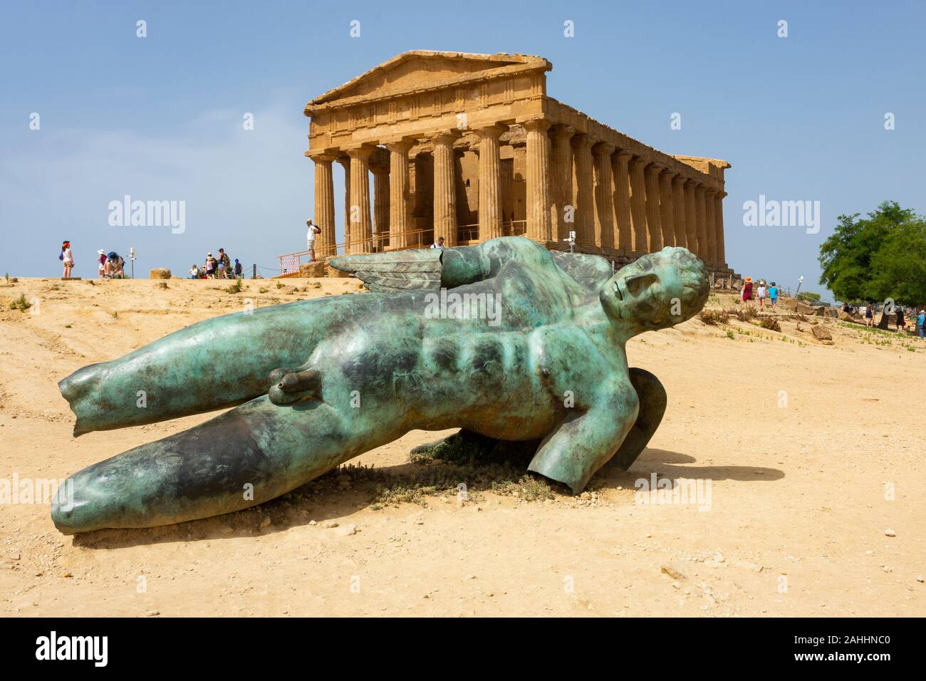 Temple of Concordia and the statue of Fallen Icarus, in the Valley of the Temples, Agrigento, Sicily, Italy Stock Photo