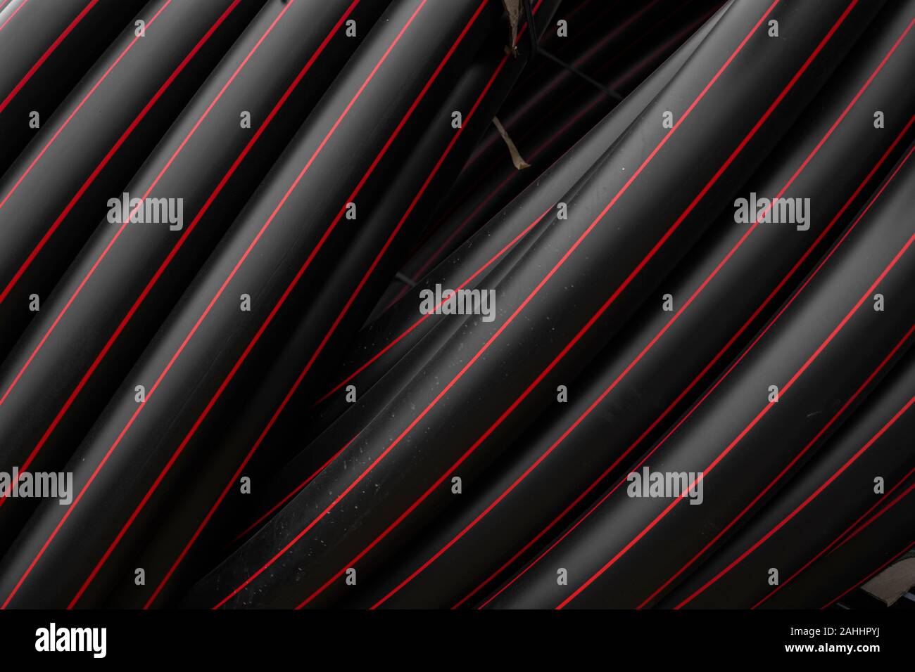 Pipe Red Line Black rubber or plastic pipes with a red lines as a construction ...